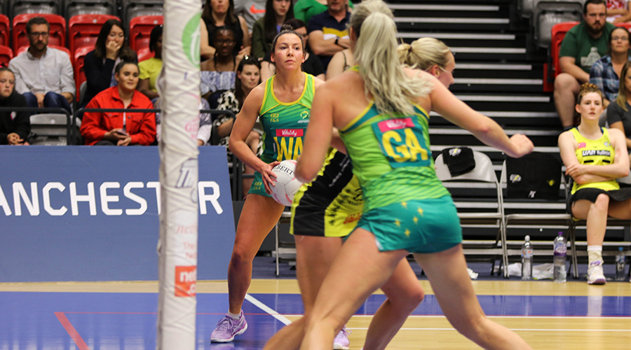 Australian Diamonds midcourter Kelsey Browne sets up to pass to shooter Gretel Tippett in a warm up match against the Manchester Thunder before the 2019 Netball World Cup.