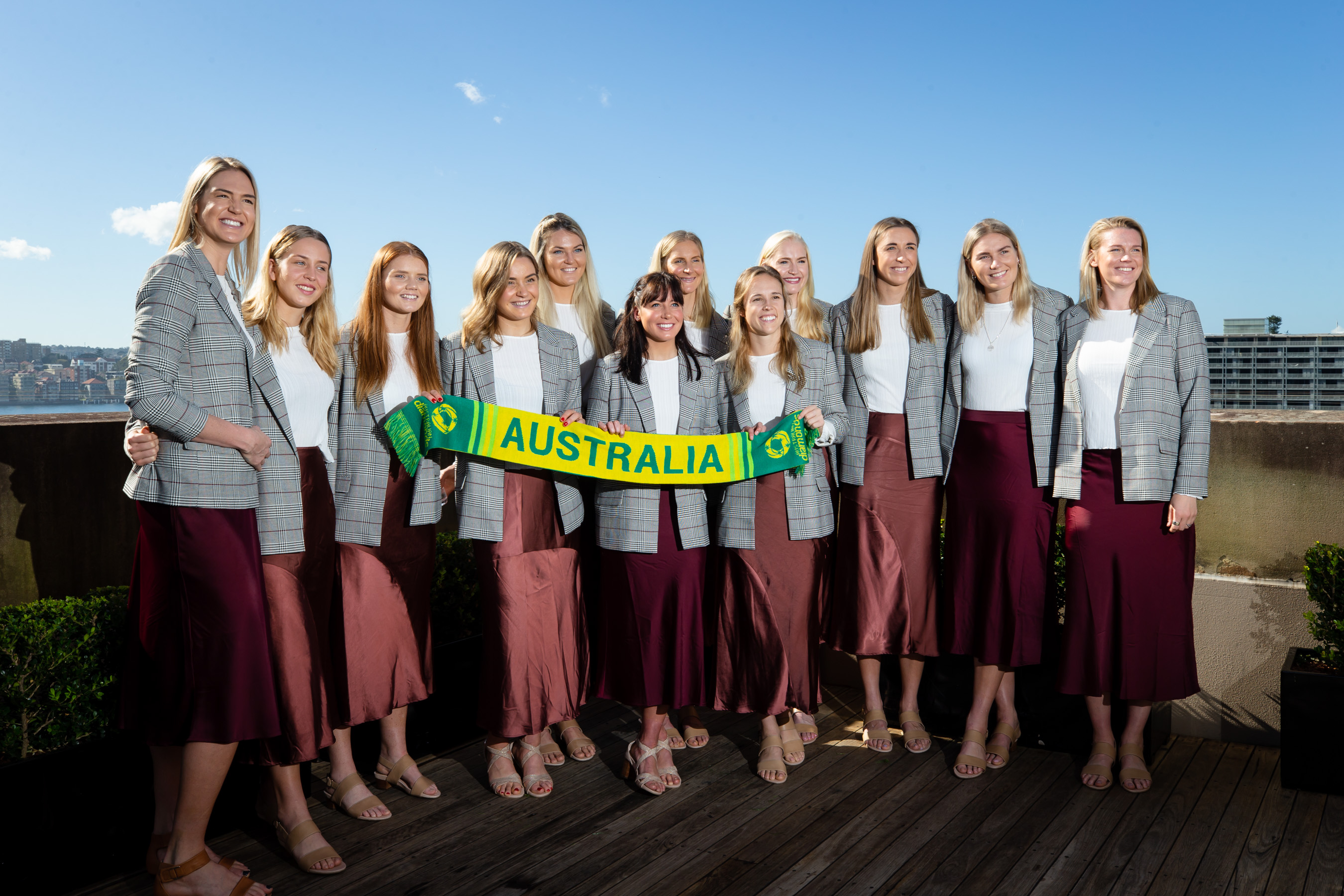 The Samsung Australian Diamonds pose for the cameras at their 2019 Netball World Cup farewell luncheon overlooking the Circular Quay in Sydney.